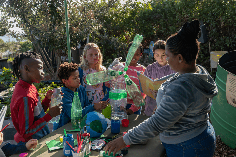 Students using recycled bottles to build an innovation project.