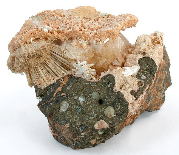 Shown is a colour photograph of different shapes of crystals growing in rock.